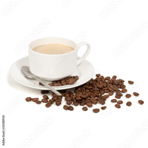 White porcelain cup and saucer with a silver spoon filled with fresh hot coffee with froth and some roasted coffee beans around, isolated on white background with object shadow. 