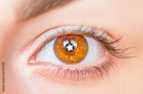 Close up of white star in young girls hazel eye