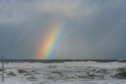 rainbow over the Pacific Ocean with stormy skies