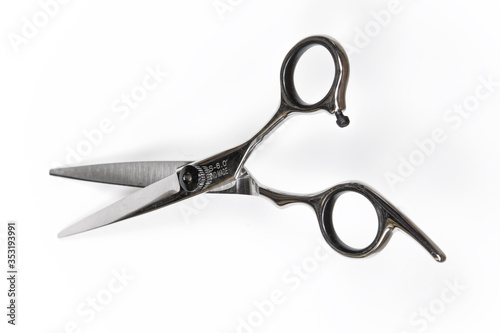 Professional hairdresser scissors, on a white background, top view