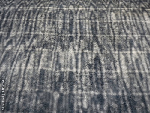 Cement concrete ground floor and shadow of sun shade net.
