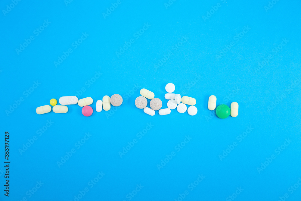 Heap of colorful pills on blue background Heap of colorful pills on blue background