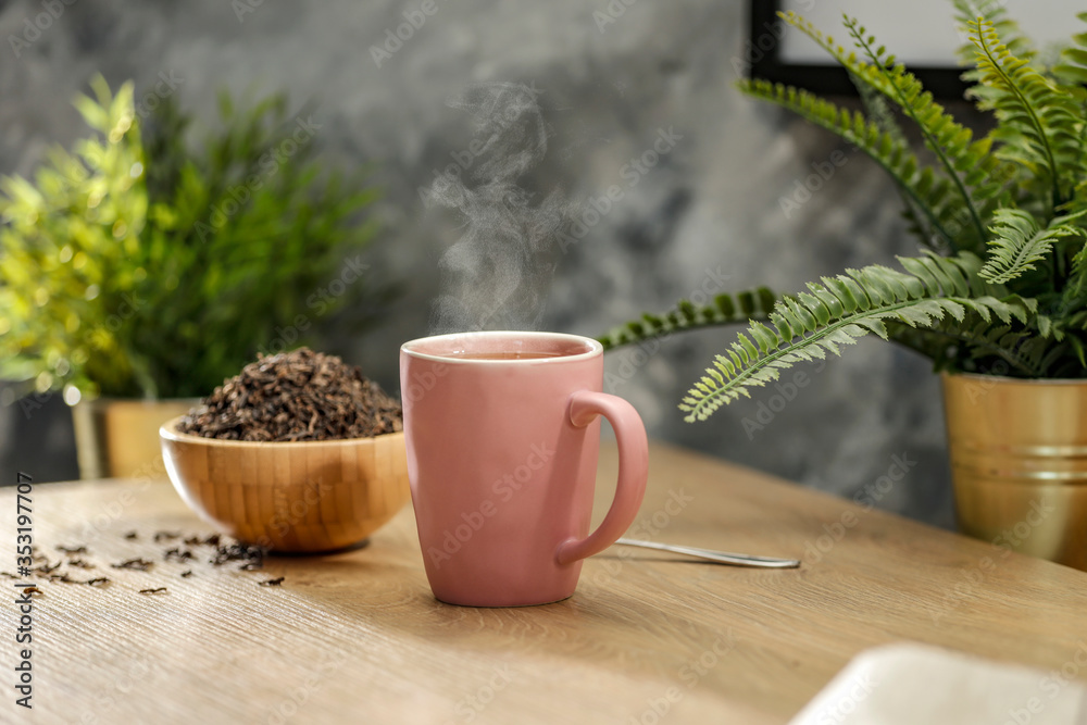 Hot tea on the table while relaxing with free space for an advertising product