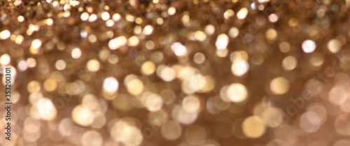 Christmas light background. Holiday glowing backdrop. Defocused Background With Blinking Stars. Blurred Bokeh.