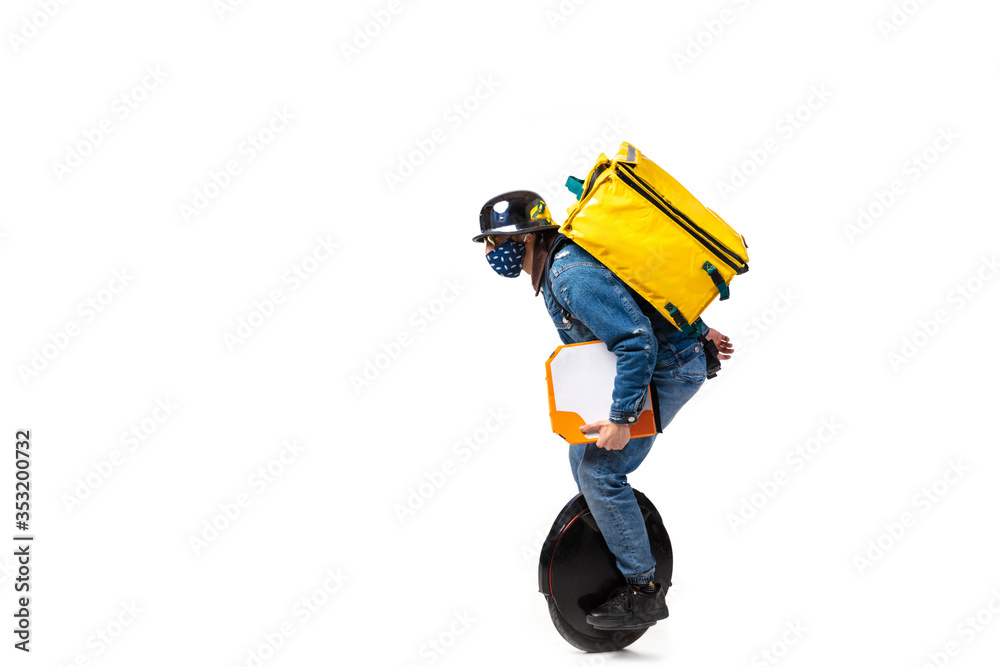 Too much orders. Contacless delivery service during quarantine. Man delivers food wearing gloves and face mask isolated on white. Taking pizza on unicycle isolated on white background. Safety.