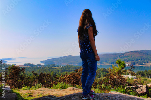 girl on the top of the mountain with view over Ria de Arousa photo
