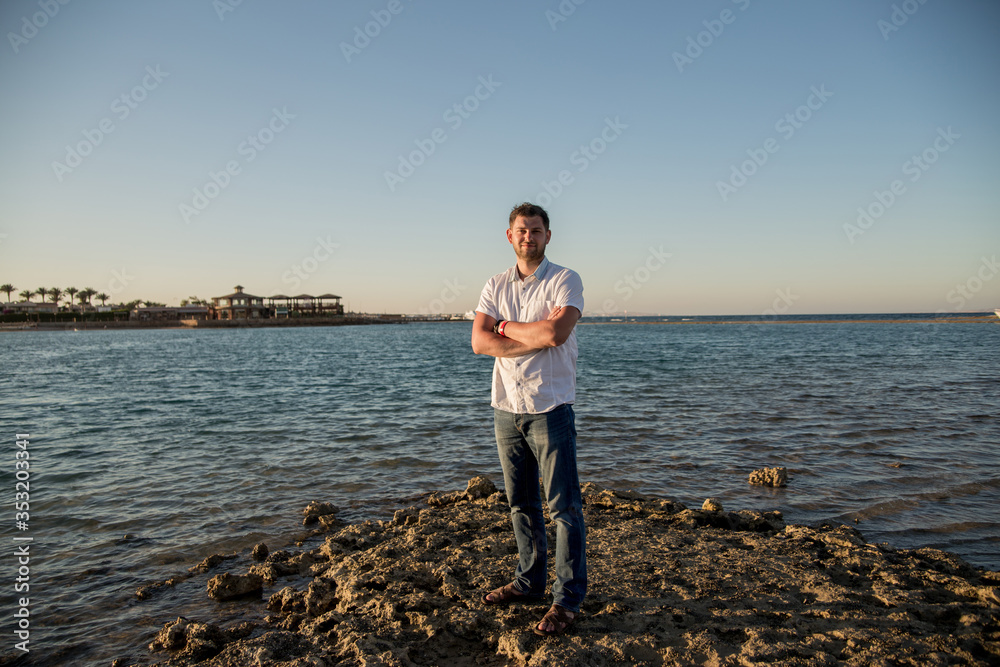 a man in a shirt near the sea