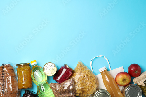 Foto Different food on blue background, top view. Donation concept
