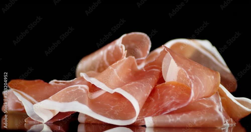 Antipasto of slices of bacon slowly rotates.