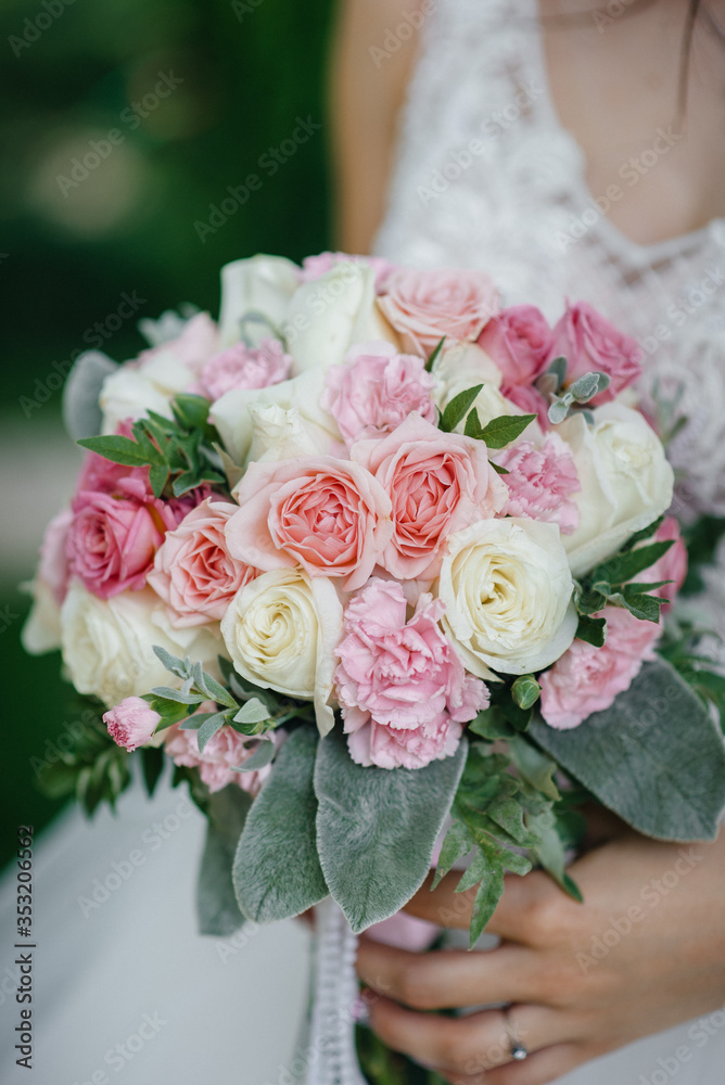 Beautiful and sophisticated wedding bouquet close-up holds the bride in her hands. Wedding bouquet Beautiful and sophisticated wedding bouquet close-up holds the bride in her hands. Wedding bouquet