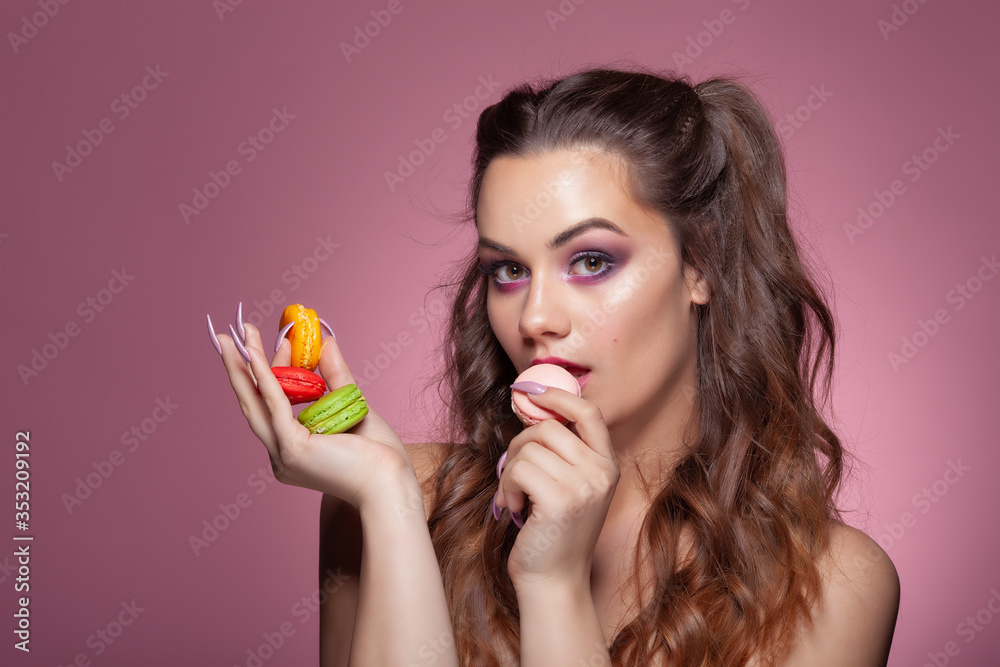 Young sexy woman eating color macarons candies Young sexy woman eating color macarons candies
