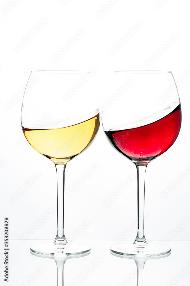 Two glasses with wine on a white background. Red wine. White wine. Apple juice. Cherry juice. Two glasses with wine on a white background. Red wine. White wine. Apple juice. Cherry juice.