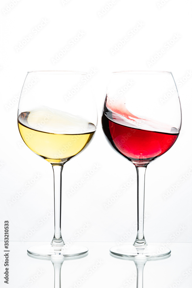 Two glasses with wine on a white background. Red wine. White wine. Apple juice. Cherry juice.