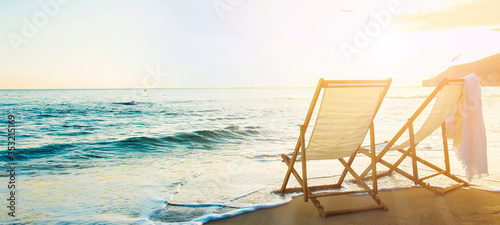 Fotografiet Background with couple of deck chairs at sunset, Travel concept, Summer backgrou