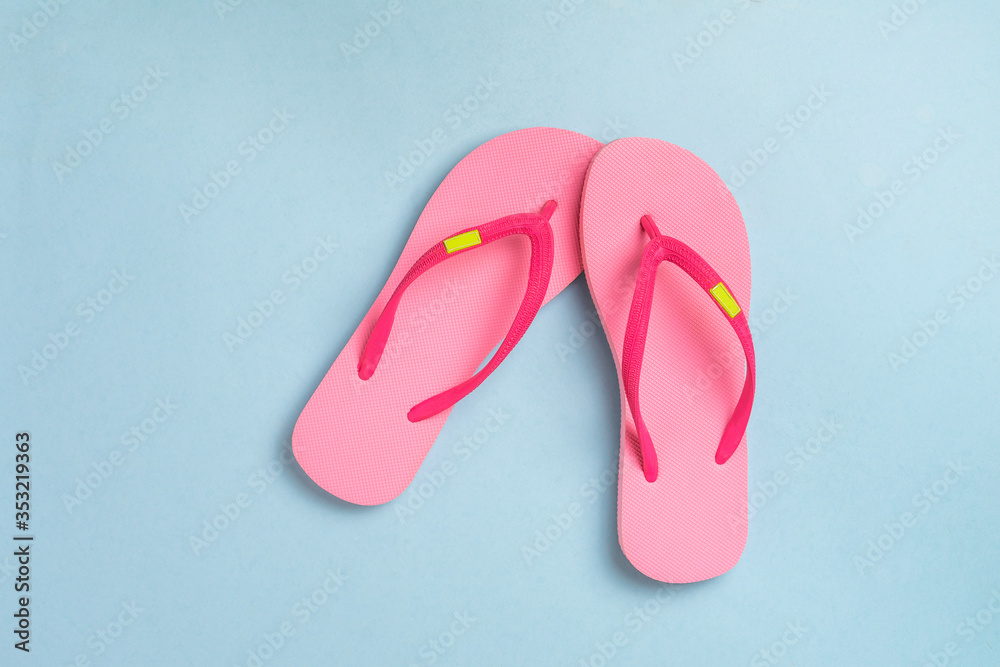 Pink sandals isolated on blue pastel background. Pink sandals isolated on blue pastel background.