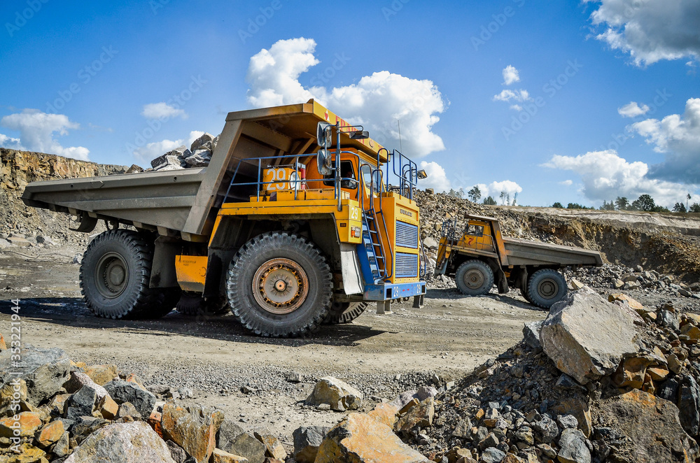 Zhodzina, Belarus - August 16, 2013: Granite mining in Quarry Trucks quarry of BelAZ Zhodzina, Belarus - August 16, 2013: Granite mining in Quarry Trucks quarry of BelAZ