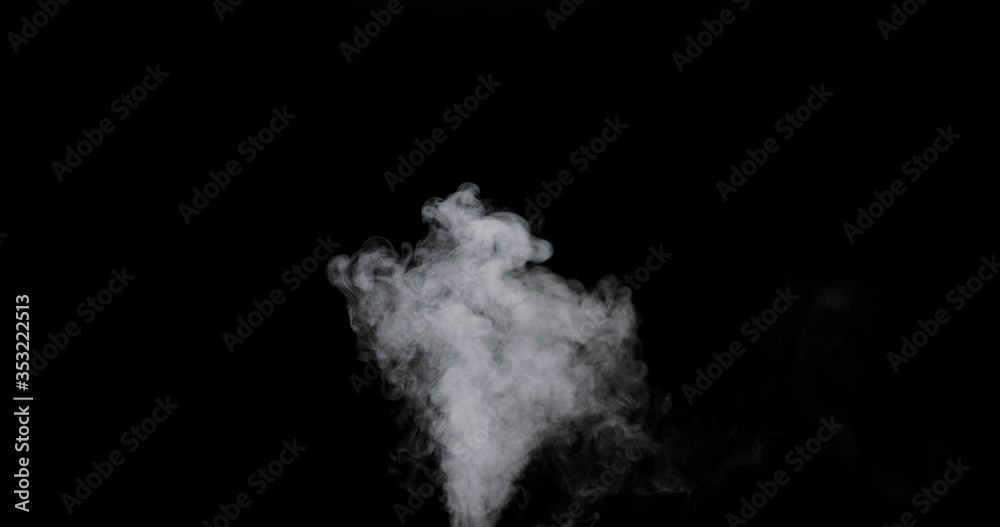 plume of smoke bubbling up against a black background. plume of smoke bubbling up against a black background.