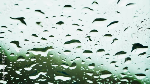 Raindrops on the windshield of the car. Windscreen with heating threads. Color graded.