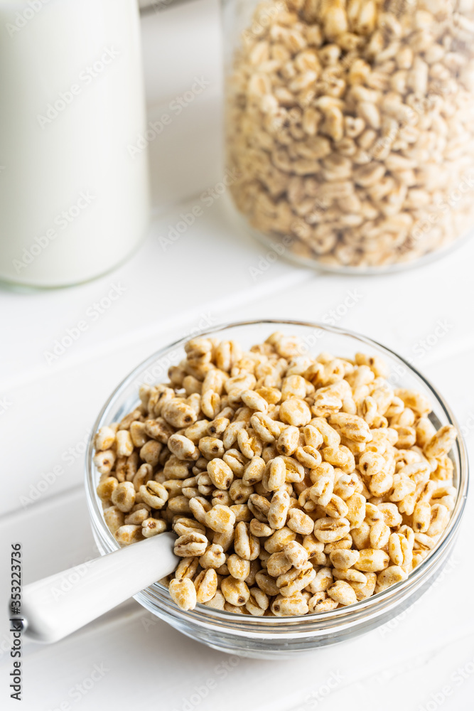 Puffed wheat covered with honey in glass bowl. Cereal breakfast. Puffed wheat covered with honey in glass bowl. Cereal breakfast.