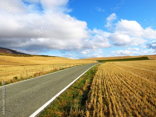 Sunny day on a road through fields in Spain