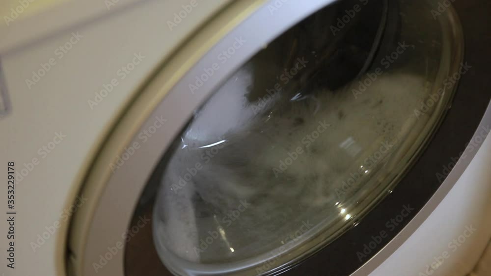 The operation of the washing machine.Water saving concept.Close-up.