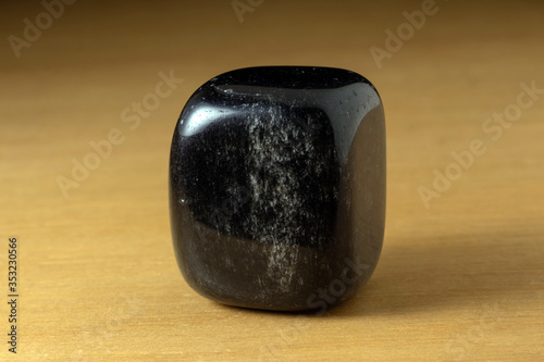 Black onyx polished gemstone from China over a wooden table