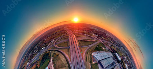 A beautiful panoramic aerial drone view of the sunset on the highway overpass of the southern Warsaw bypass (Polish: POW), Michalowice district in Warsaw, Opacz Kolonia, Poland photo