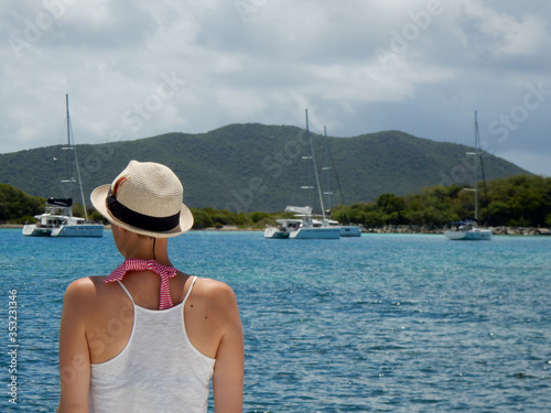 Woman wearing a hat on a summer sailing vacation in the British Virgin Islands