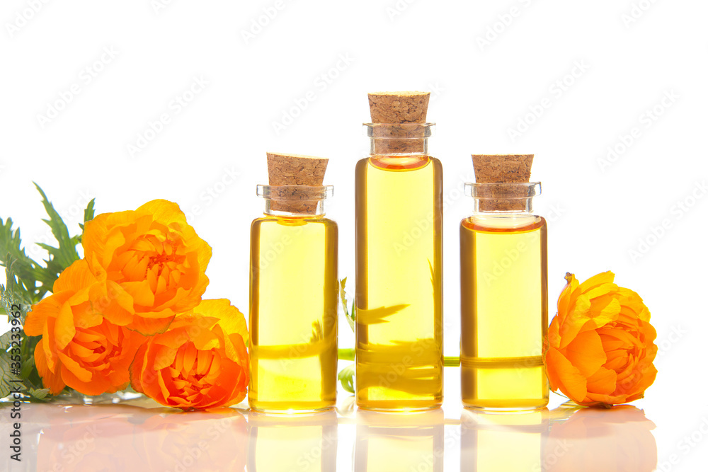 Essence of Globeflower flowers on White background in beautiful glass Bottle Essence of Globeflower flowers on White background in beautiful glass Bottle