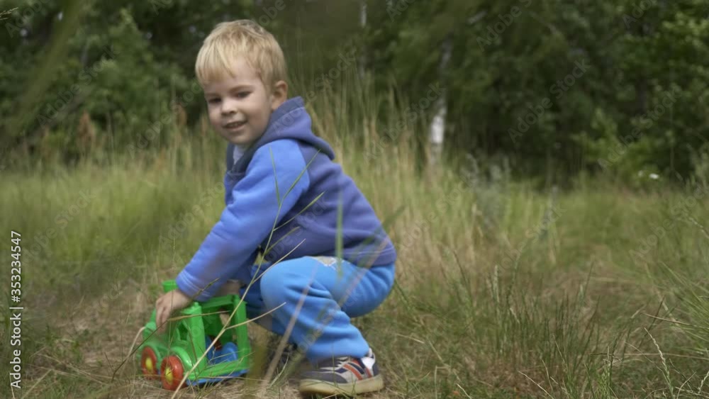 Joyful Little Boy Playing in High Grass Field. Bright Sunny Summer Day Joyful Little Boy Playing in High Grass Field. Bright Sunny Summer Day