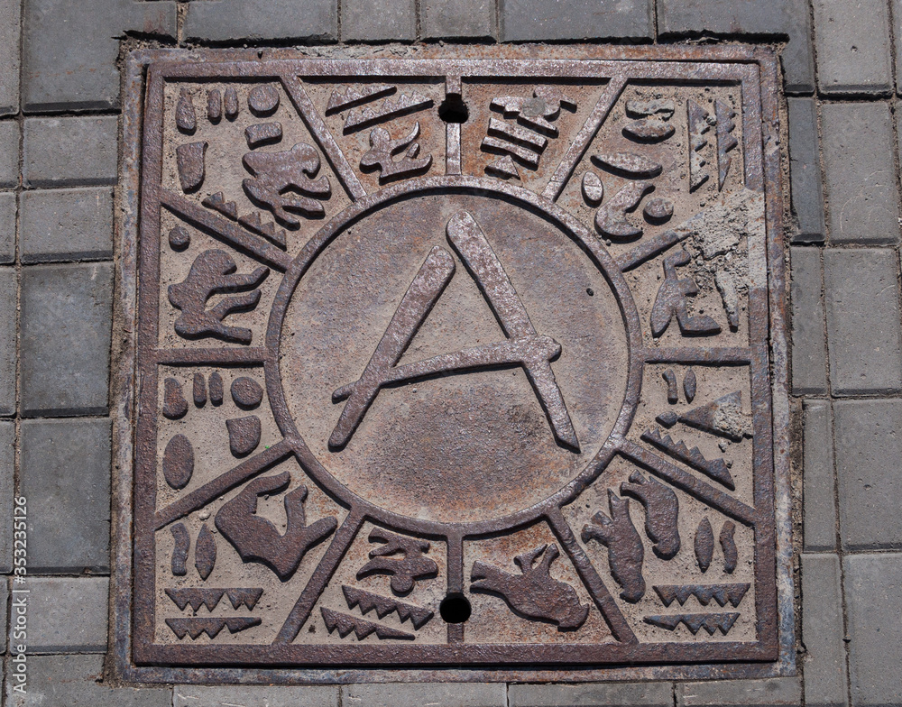 Metal hatch with the Egyptian symbolics on the area in Kazan.