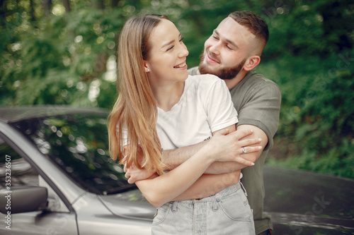 Couple in a forest. Man in a green t-shirt. Pair near car © prostooleh