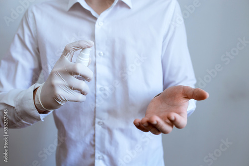 man pokes antiseptic on his hand, coronavirus