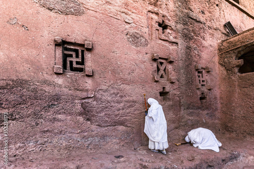 Piligrims at lalibela church stone wall