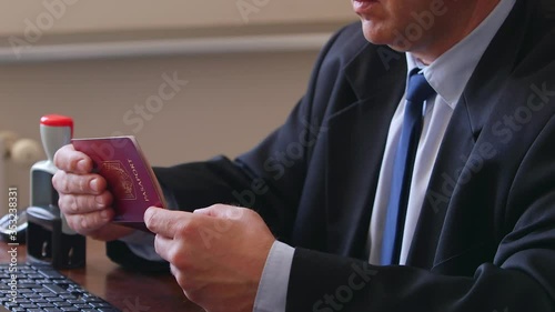 The immigration control officer verifies passport identification data.
