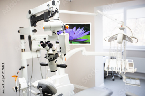 Modern Dental Clinic, Dentist chair and other accessories used by dentists in medical light. Dental surgeon, is a surgeon . Dentist's office. Dental equipment in modern, clean interior