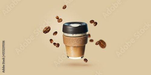 Mockup with flying reusable takeaway coffee cup with coffee beans. Reusable coffee cups. Zero waste. Template for coffee menu.