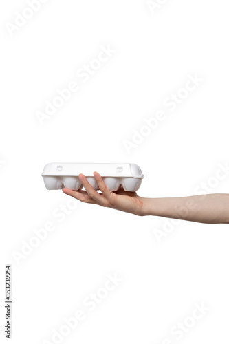 eggs held in hand isolated on white background. man holding plastic package in palm. delivery from shop to home. food supplies, donation, volunteer. product ingredients for dish, cooking meals