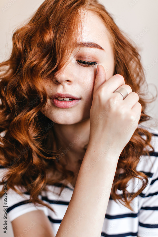 Close-up portrait of spectacular european lady wears silver ring. Joyful ginger girl posing with eyes closed. Close-up portrait of spectacular european lady wears silver ring. Joyful ginger girl posing with eyes closed.