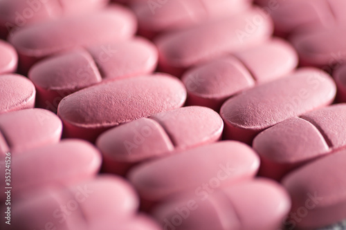 Rows of pink pills. Macro image.