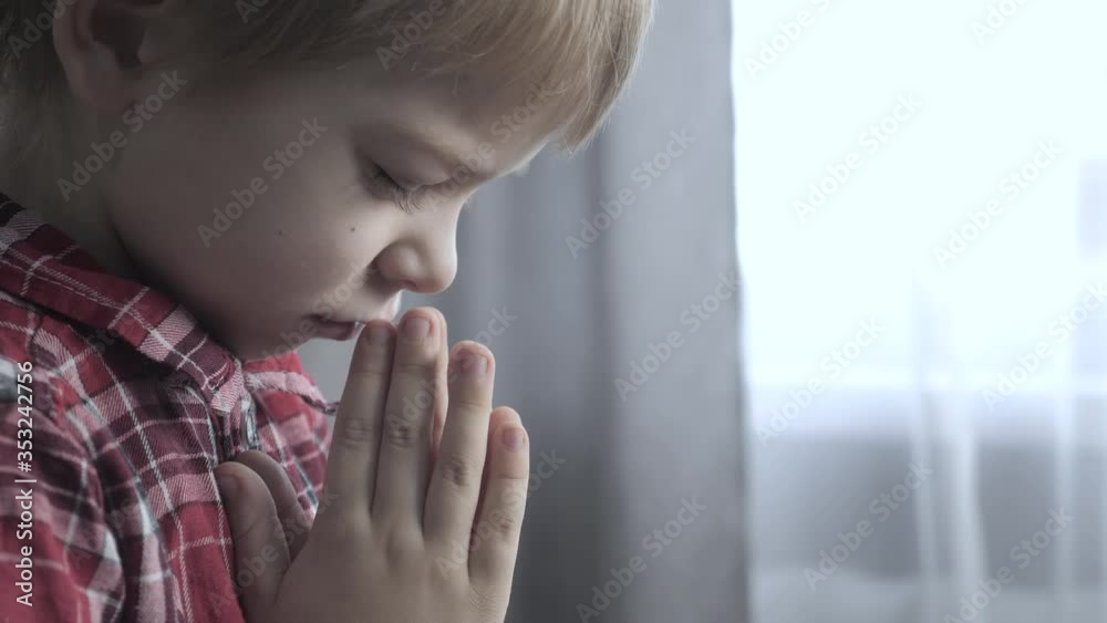 little son boy makes a wish prays bedtime religion concept. prayer child indoors praying by bed in front lifestyle of window little son boy makes a wish prays bedtime religion concept. prayer child indoors praying by bed in front lifestyle of window