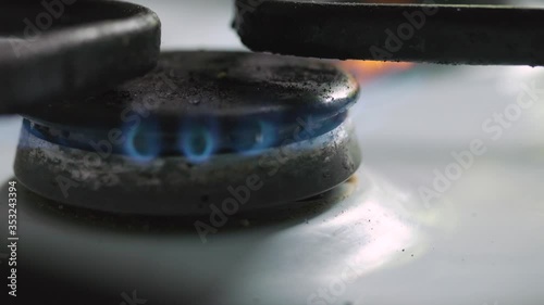 the gas burner is ignited by the lighter. blue flame of a gas stove