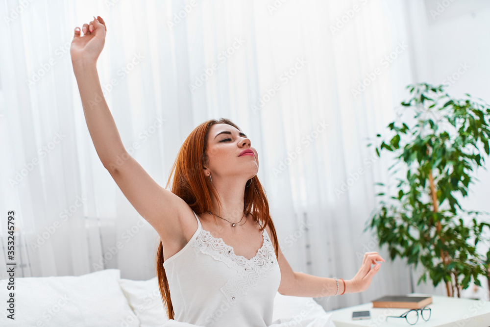 Woman stretching after waking up Entering a day happy after good night sleep. Woman stretching after waking up Entering a day happy after good night sleep.