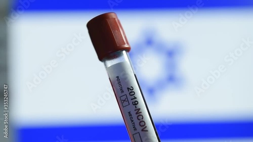 Corona virus or Covid-19 in Israel , sample blood tube with Israel flag on background
