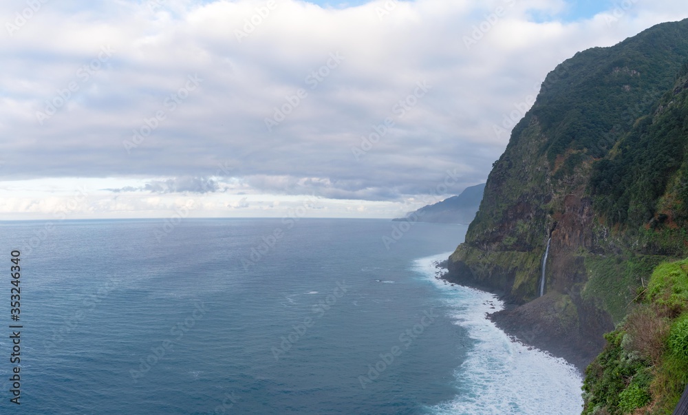View of waterfalls flowing into the ocean close to Seixal town in Madeira