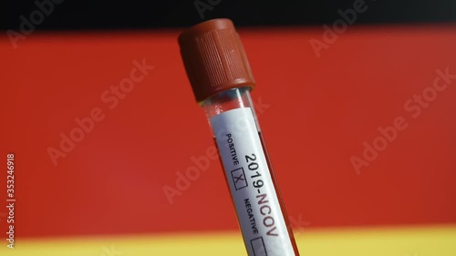 Corona virus or Covid-19 in Germany , sample blood tube with Germany flag on background