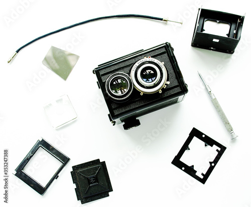 Old TLR camera, disassembled into parts, isolated. photo