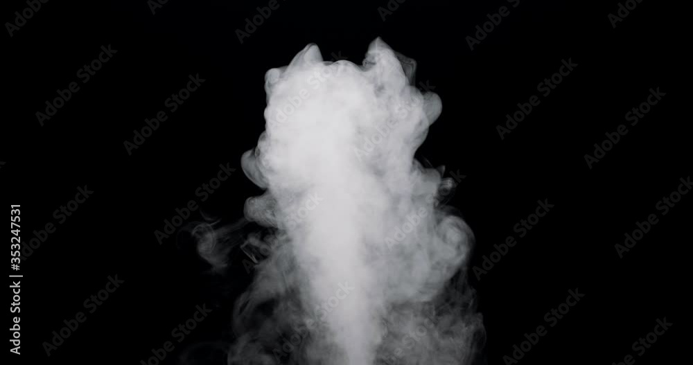 plume of smoke bubbling up against a black background. plume of smoke bubbling up against a black background.