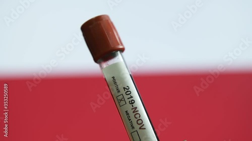 Corona virus or Covid-19 in Poland , sample blood tube with Poland flag on background