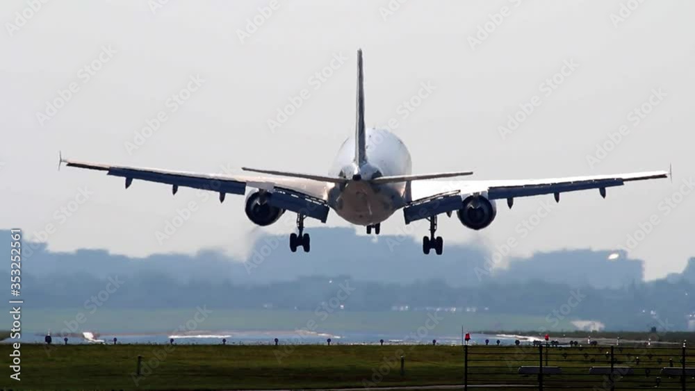 Big Airliner is landing on runway at HAM Hamburg Airport Germany at daytime Big Airliner is landing on runway at HAM Hamburg Airport Germany at daytime